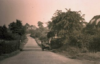 Daws Heath Road as it once was. The picture is taken beside what has become Deanes School entrance looking east. Hilltop Cottage, formerly known as Oo-oo Cottage, is to the immediate right and is still there today | H&TCA