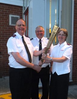 John Willson (centre) from Hadleigh Temple Salvation Army showing his Olympic Torch to Comm. André & Sylvia Cox | Brian Nichols