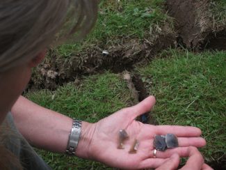 Dr Carenza Lewis deciding if this flint is prehistoric | Terry Barclay