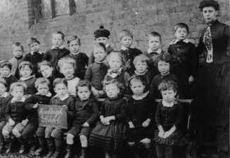 Emma Bell with her infant class in c.1889